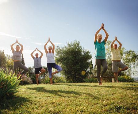 older people practicing yoga at ach retirement living location
