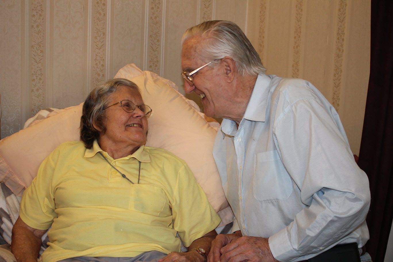 two older people smiling