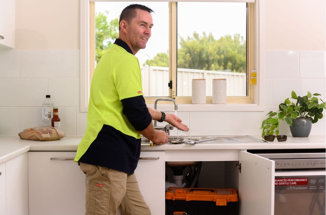 maintenance man at sink