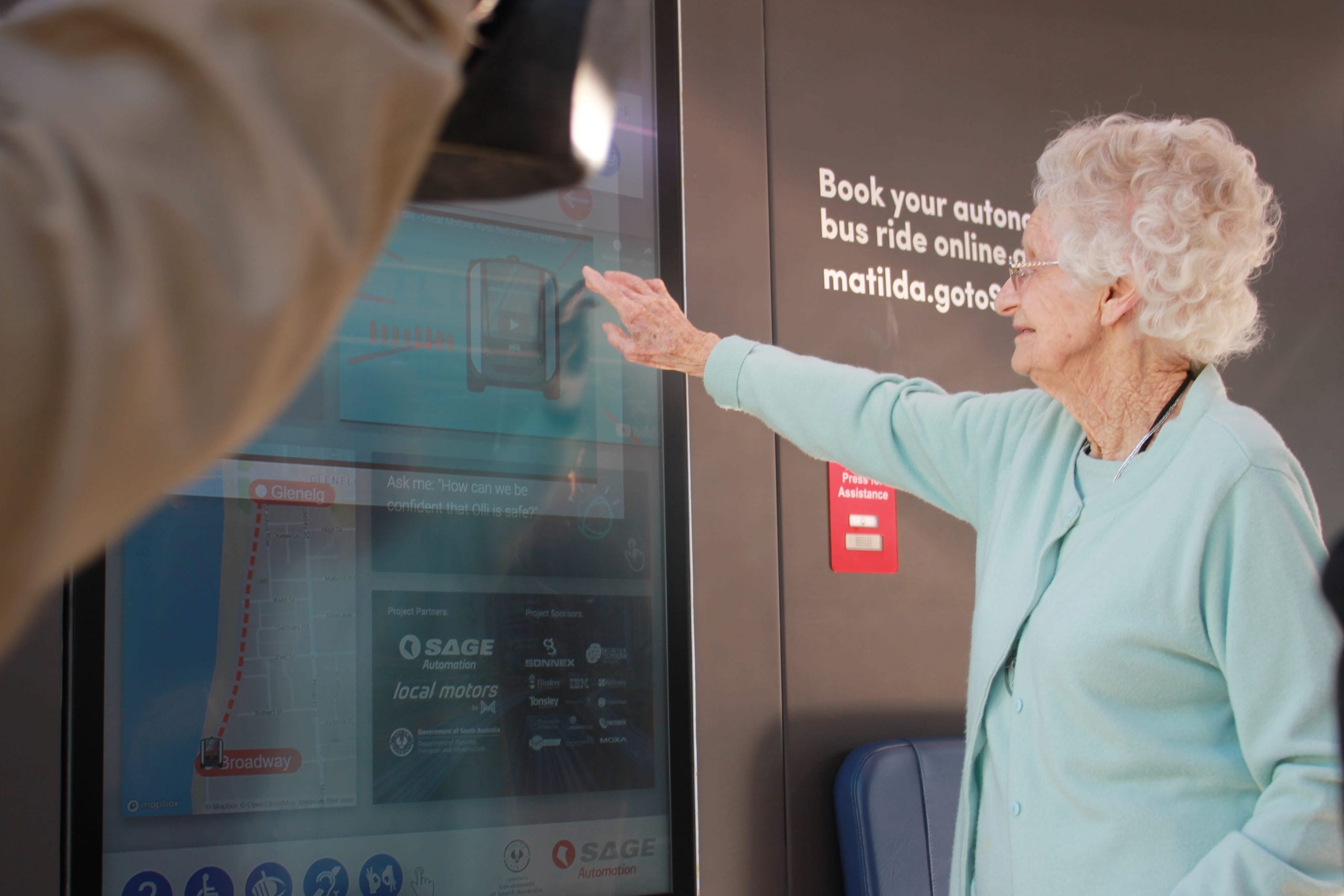 older woman booking driverless bus in glenelg