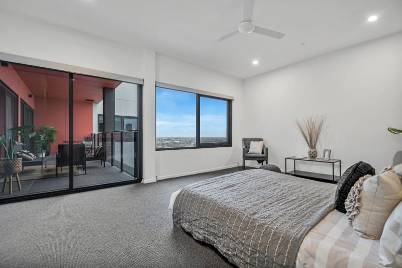 spence on light city living bedroom looking onto balcony