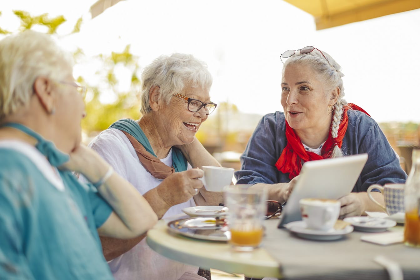 A group of older woman having coffee and enjoying their worry free retirement living lifestyle