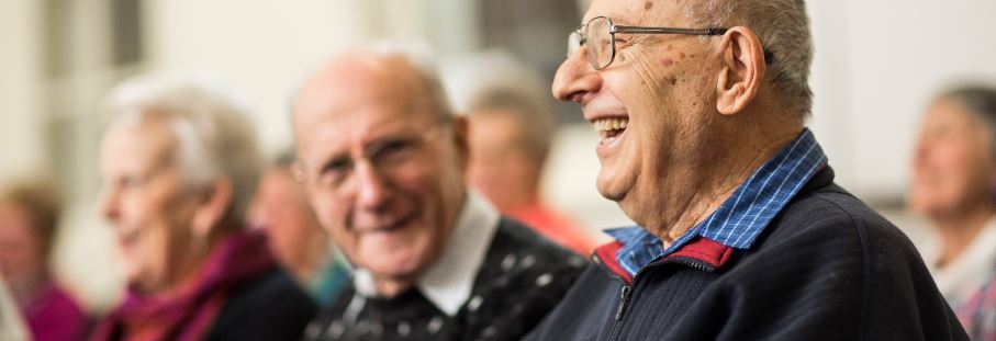 Older man having a good laugh, feeling socially connected