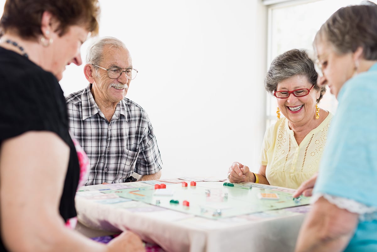 older people playing monopoly