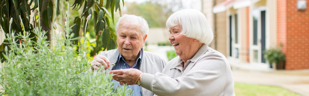Two older people enjoying outdoor garden