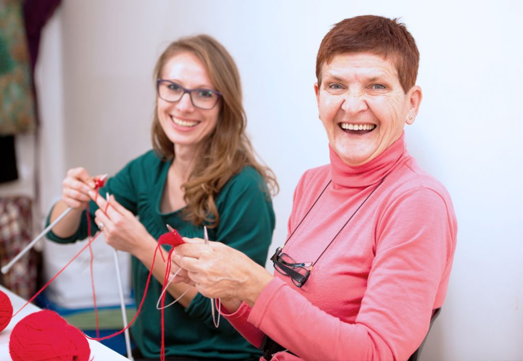 Two happy ladies enjoying knitting