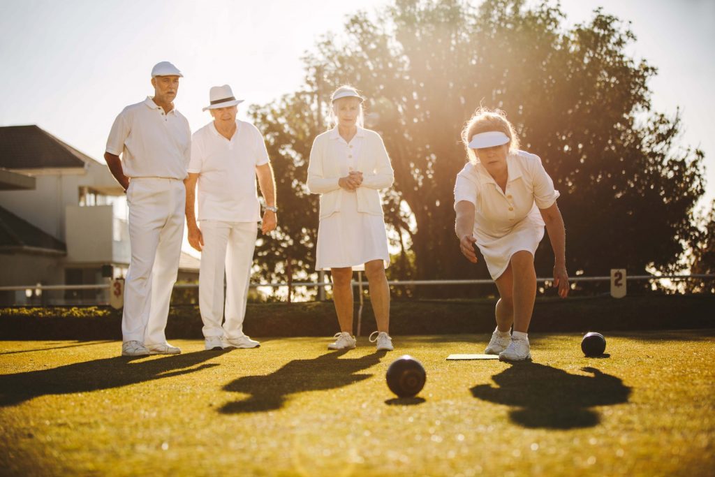 A group of people playing lawn bowls