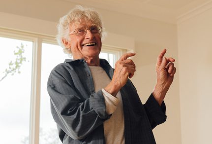 Older gentleman dancing and smiling