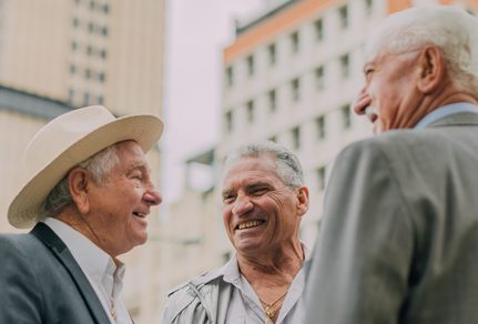 Group of older gentlemen catching up in the city