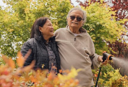 Older couple enjoying life, watering garden