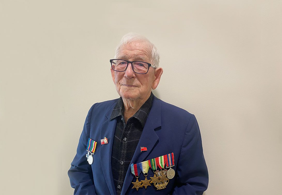 Jack Nicholls from Yankalilla Centre Residential Care Home talks about his experience as a WWII veteran, wearing a jacket with war medals and badges.