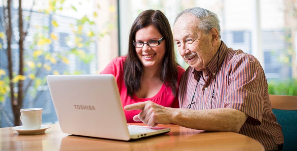 Consumer Advisory Body - two people looking at a laptop screen, discussing feedback