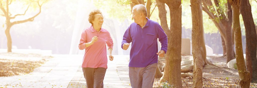 Older couple exercising outdoors