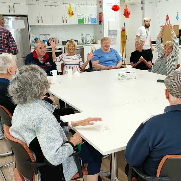 A group of West Park Aged Care Home residents, eagerly waiting for their no bake passionfruit custard slice to be ready