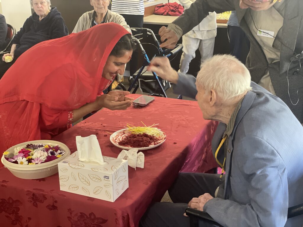 Bill, who recently celebrated his 102nd birthday, joined in the festivities as the eldest person at Milpara by putting tika, a ceremonial mark applied on the forehead, as a sign of respect and blessings.