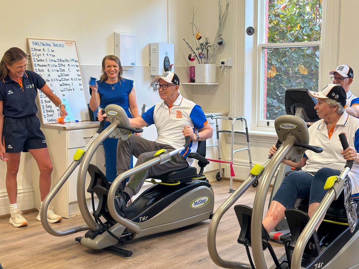 Gym at Kapara, residents on exercise bikes, joining the cycling challenge