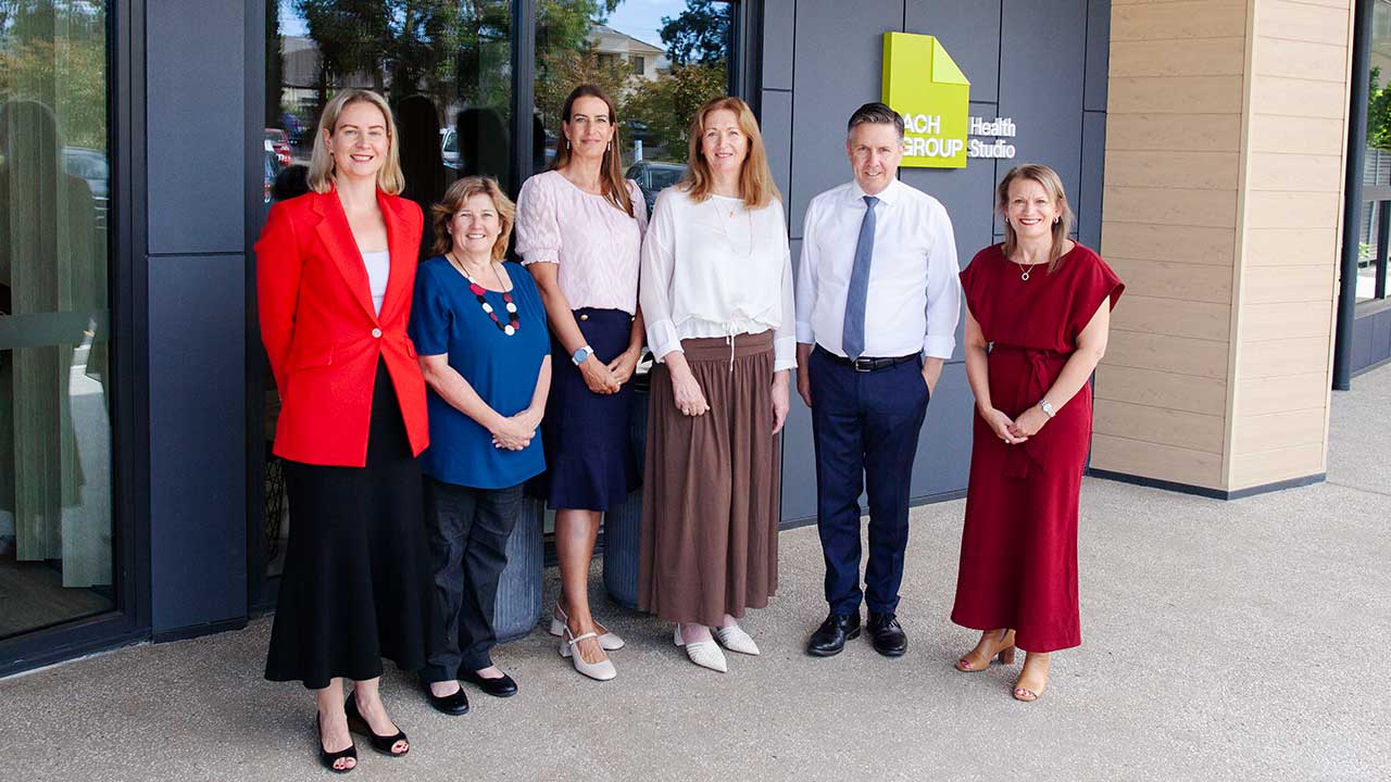 Photo of ACH Group Chair Imelda Lynch, CEO Linda Feldt, Executive Manager Customer Care Kate Dobie, Head of Health Barbara Tainsh, the Hon. Mark Butler MP Minister for Health and Aged Care, and Claire Clutterham, Labor Candidate for Sturt - standing outside of Health Studio Rostrevor