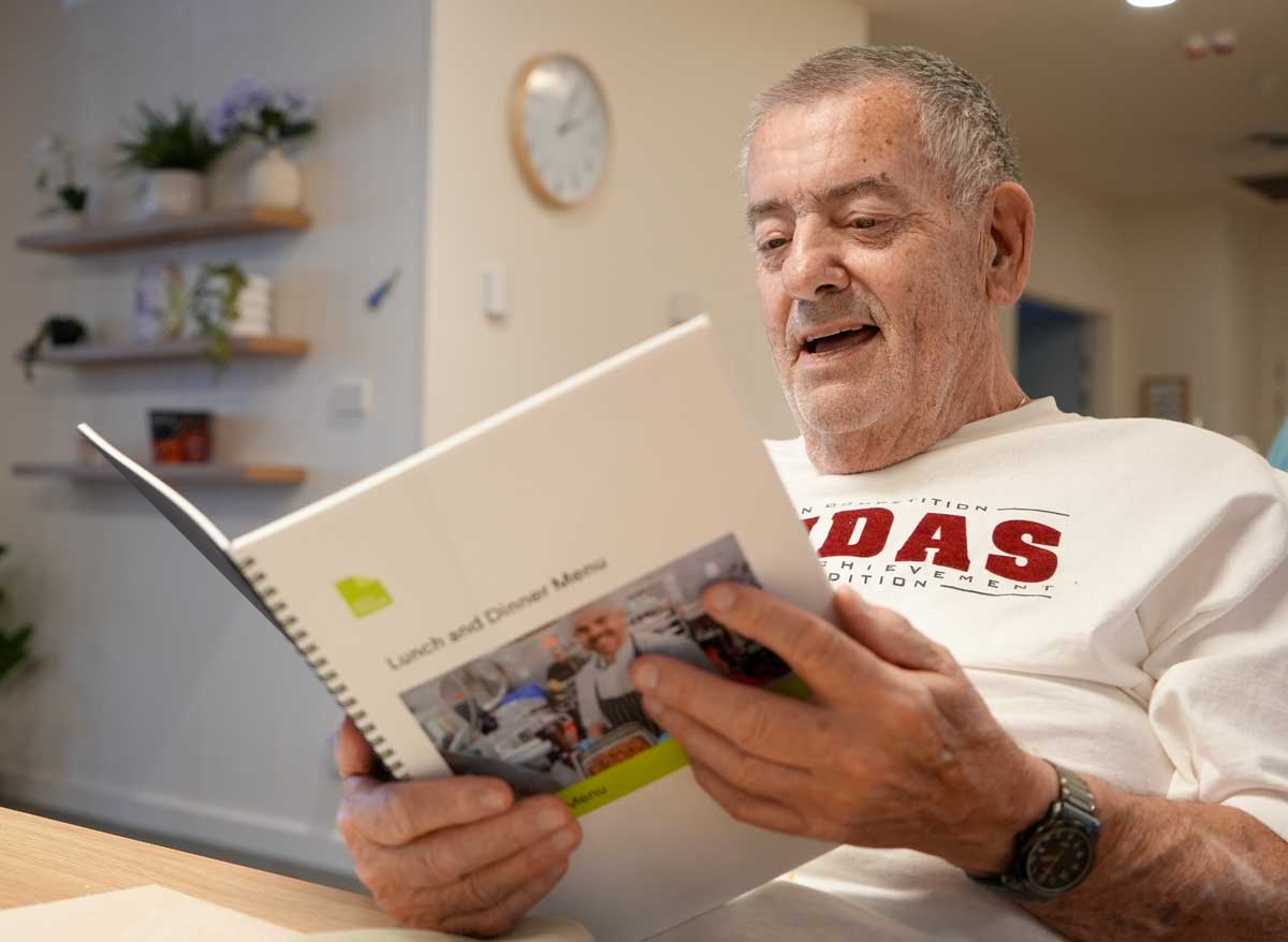 John, residenta at Healthia, reads the new winter menu.