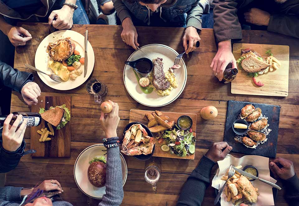 Friday night with friends, a table with food while people are enjoying themselves