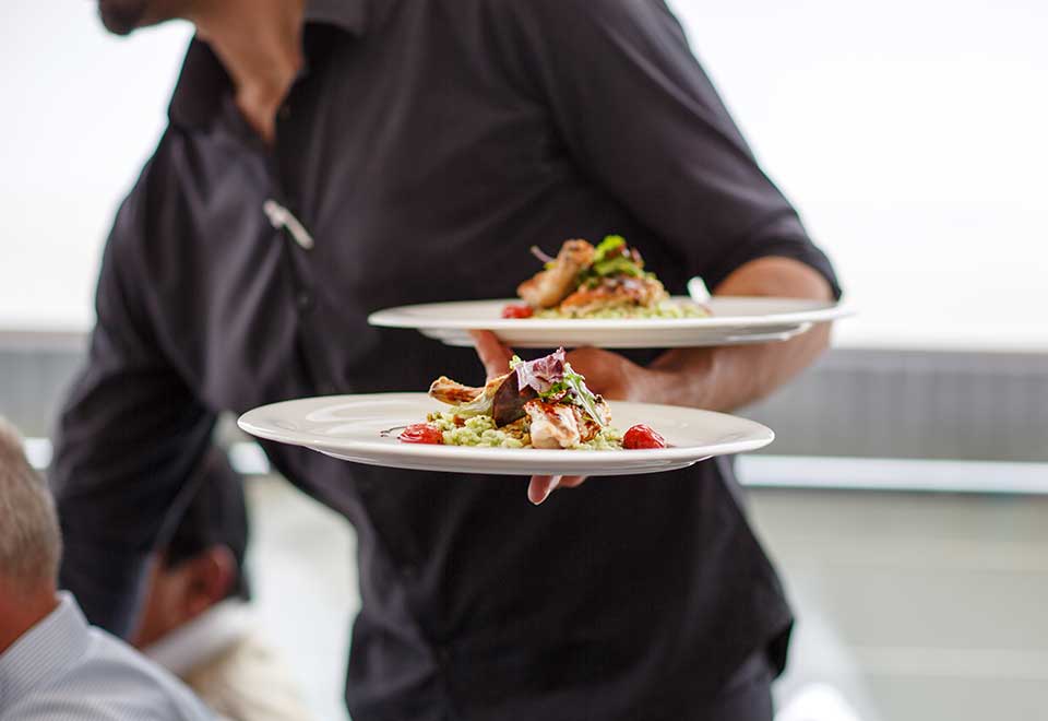 Long lunches - a waiter serving beautifully plated-up food