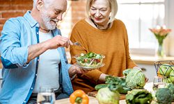 older couple preparing a salad