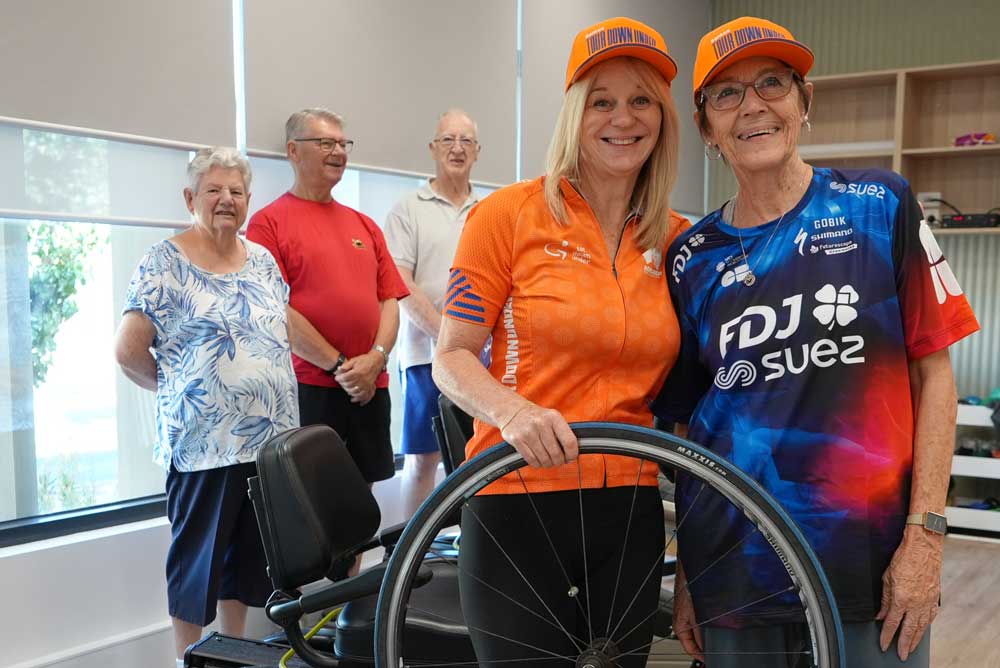 Customers in the background, Lisa - Personal Trainer and Yvonne, Customer - participating in the Cycle Challenge