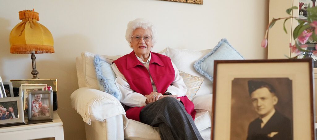 Lee Baker lives at Kapara Mews, here pictured with a photo of her husband, war hero, Maurice