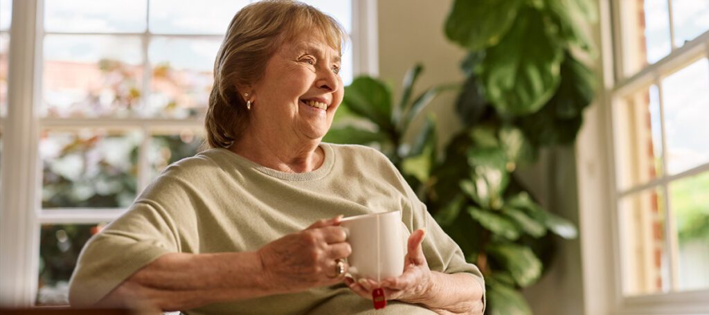 A customer enjoying a cup of tea while engaging in mindfulness and brain health activities at ACH Group