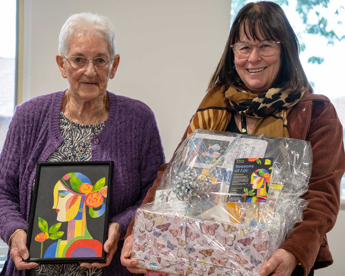 Val and Steph, with the winning artwork and gift basked