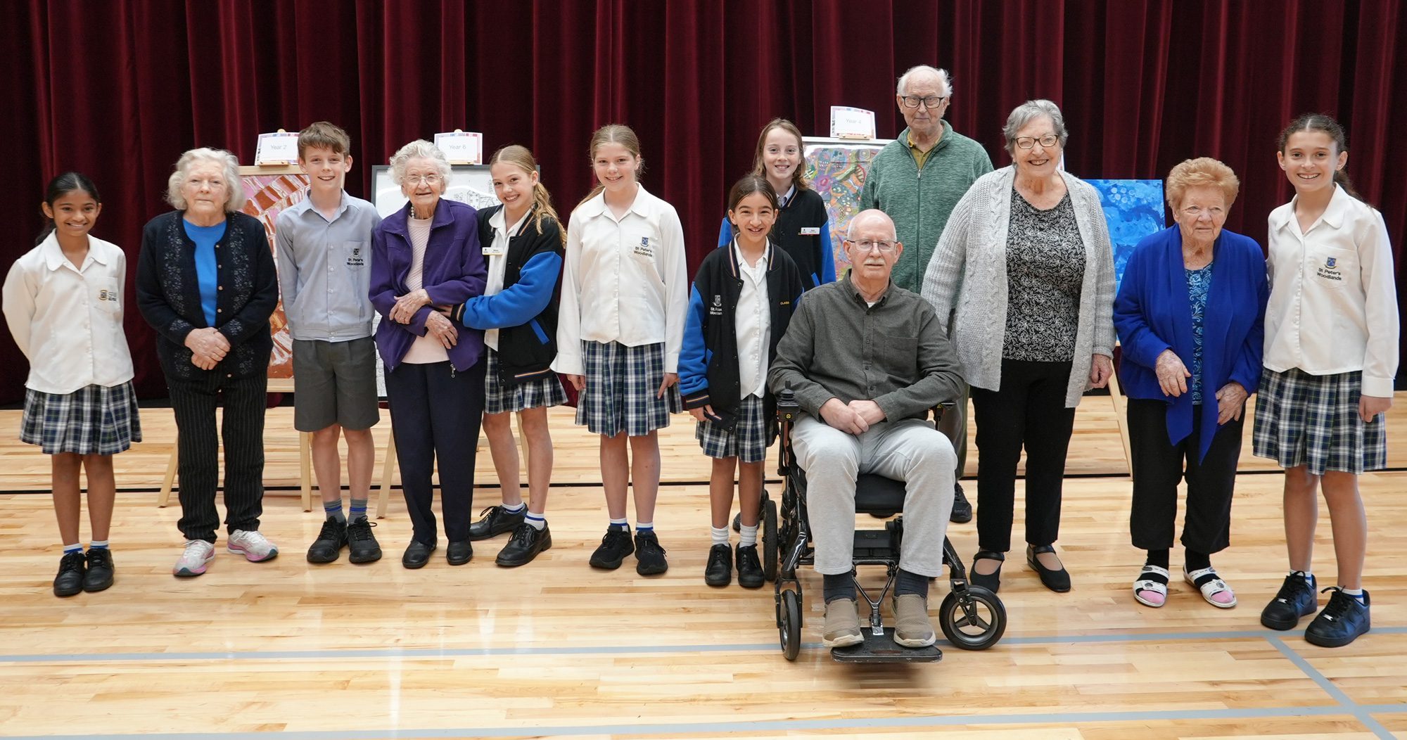 Students and residents having their photo taken at SALA Exhibition at St Peter's Woodlands