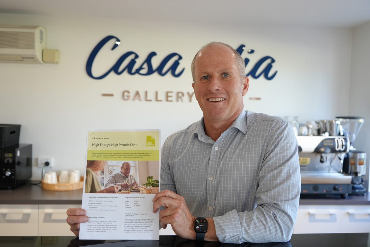 Michael Dobie showcasing one of the award-winning nutrition guides he has developed