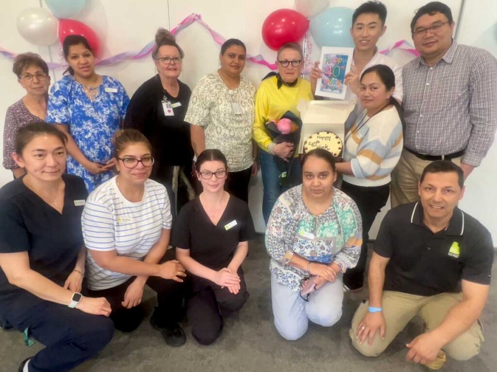 Surrounded by colleagues, Trish Cribb, centre, marks 40 years at Kapara Residential Care Home - a milestone celebrated with cake, flowers and plenty of thanks.